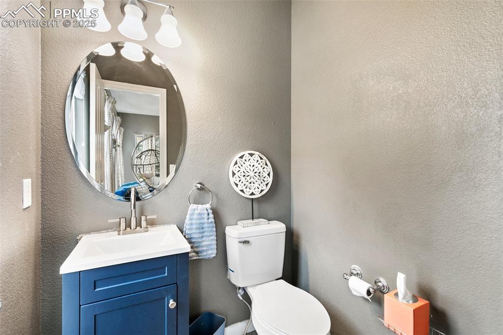 997 Burning Bush Point Monument, CO 80132 - Photo 18 of 34 a bathroom with a toilet a sink and a mirror