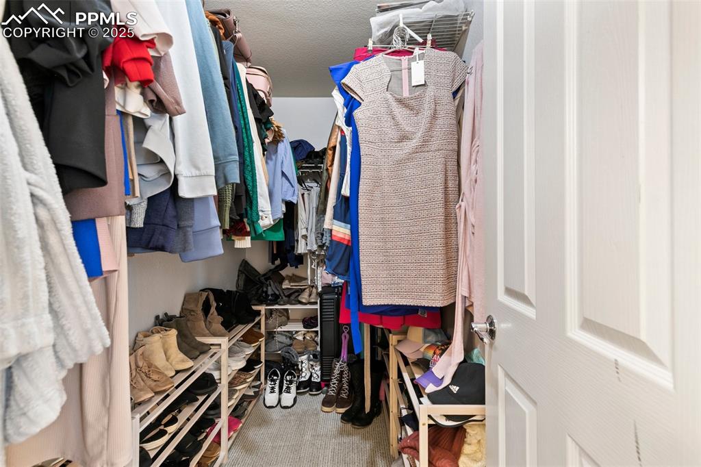 997 Burning Bush Point Monument, CO 80132 - Photo 23 of 34 a view of walk in closet with clothes