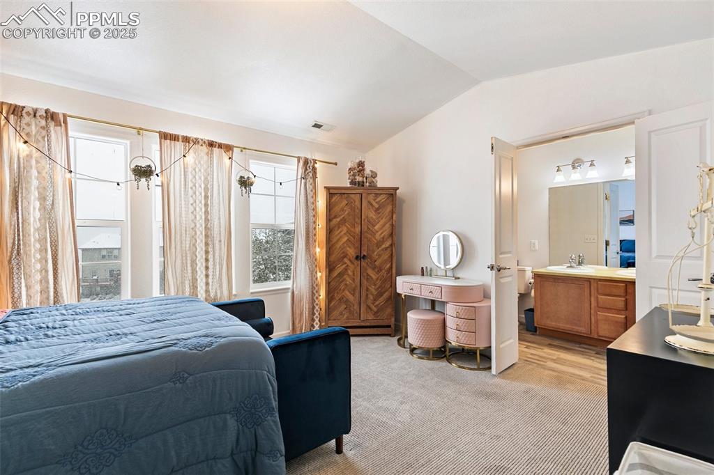 997 Burning Bush Point Monument, CO 80132 - Photo 26 of 34 a bedroom with a large bed and a large window