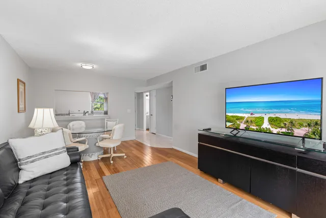 a living room with furniture a large window