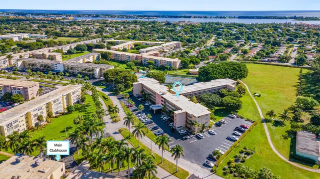 an aerial view of a house with a garden and lake view