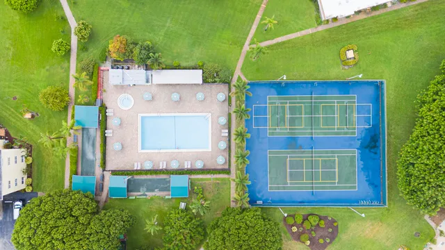 an aerial view of a swimming pool with a yard