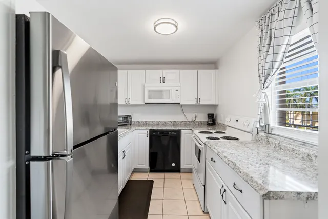 a kitchen with a stove a sink and a refrigerator