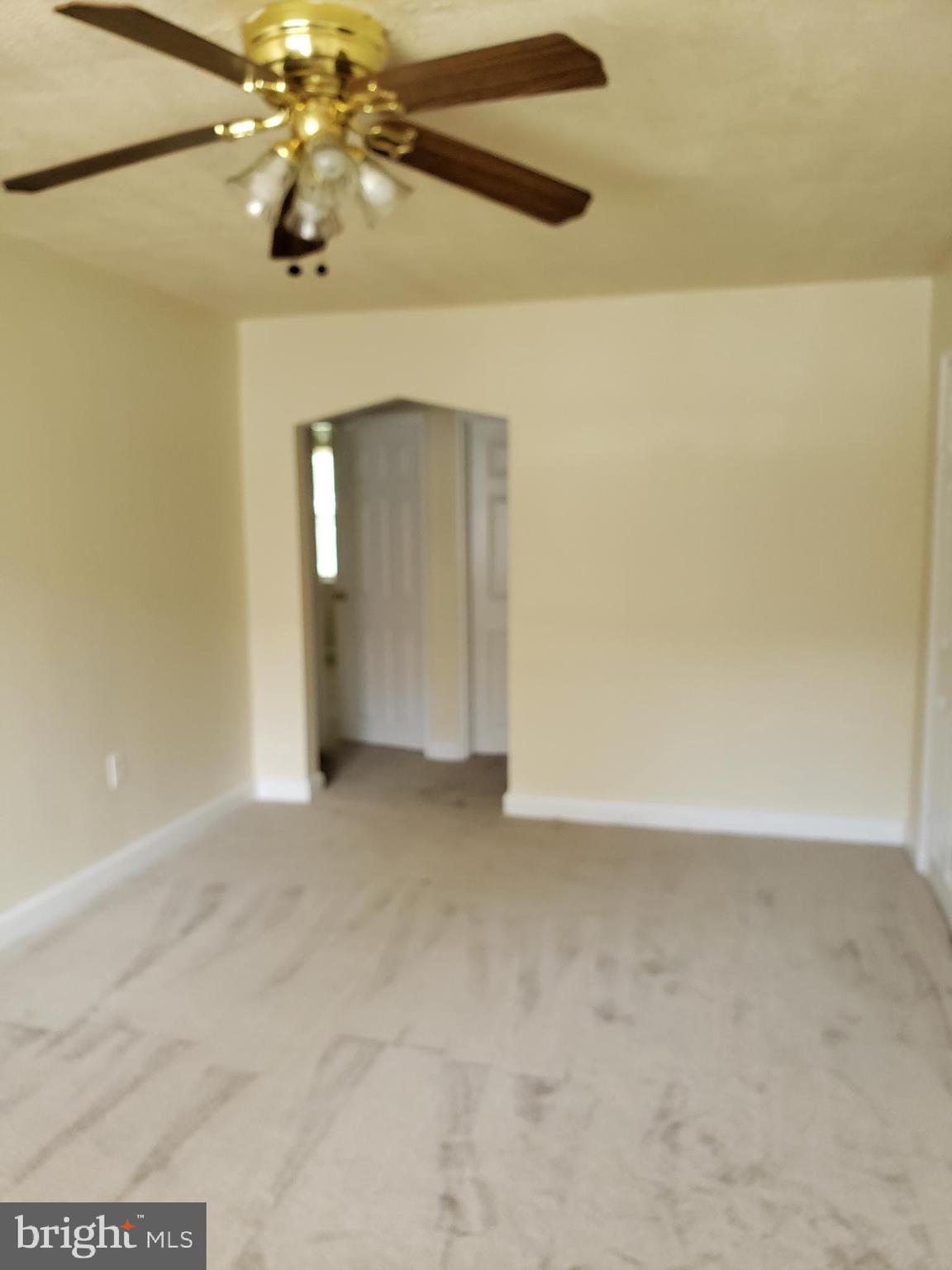 5338 Nelson Avenue, Unit 1 Baltimore, MD 21215 - Photo 2 of 11 a view of an empty room with a chandelier fan