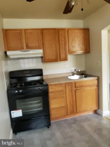a kitchen with a stove and a cabinet