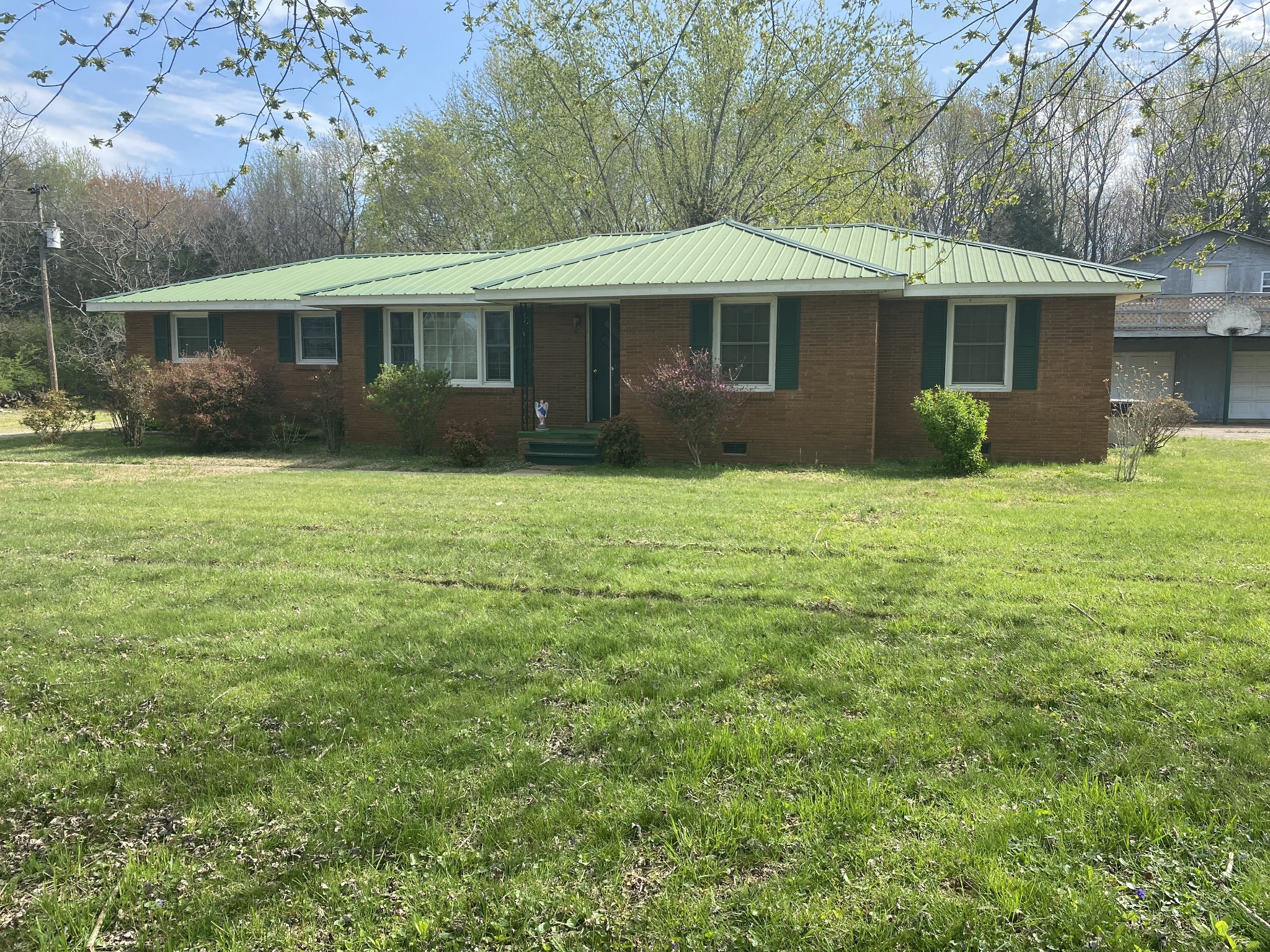 136 New Deal Potts Road Cottontown, TN 37048 - Photo 1 of 24 a front view of a house with a garden