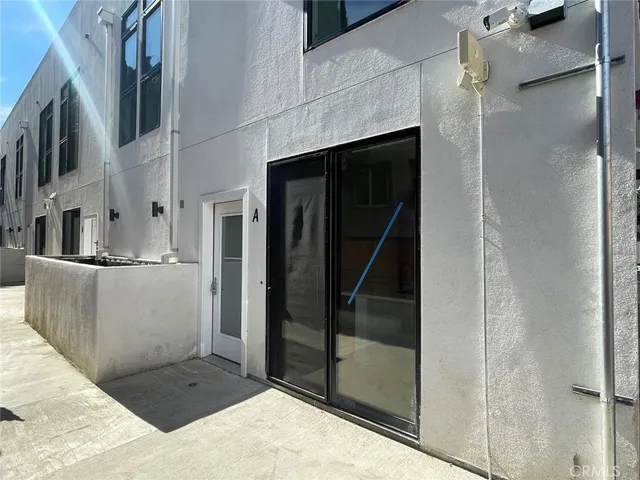 a city view with tall buildings and a car parked on road