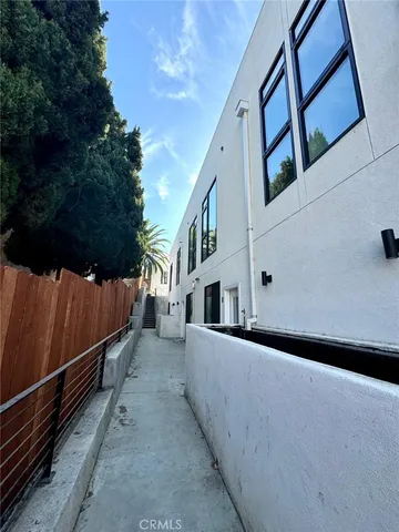 a kitchen with a sink stainless steel appliances and white cabinets