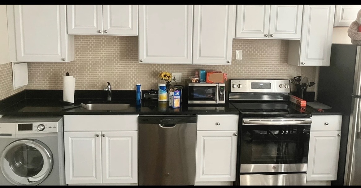 3345 North Marshfield Avenue, Unit 201 Chicago, IL 60657 - Photo 2 of 5 a kitchen with stainless steel appliances granite countertop a stove a sink and white cabinets