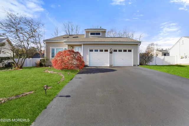 a view of a house with a yard and garage