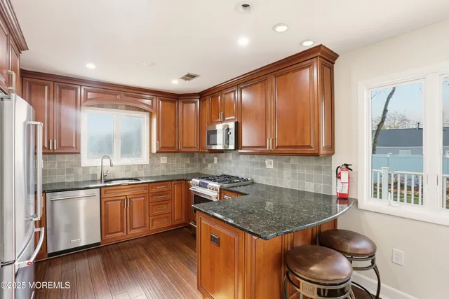 a kitchen with a sink a window and cabinets