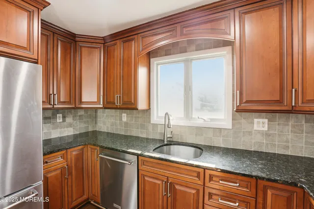 a kitchen with stainless steel appliances granite countertop a sink and a cabinets