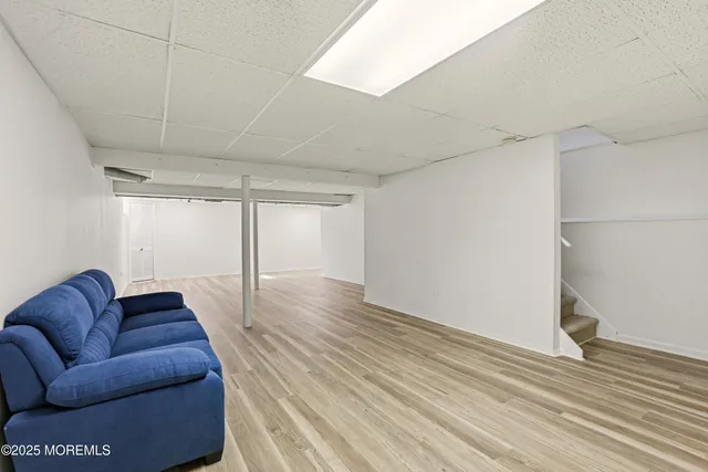 a living room with furniture and a hard wood floor