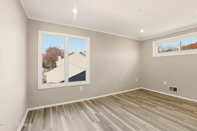 a view of a room with wooden floor and cabinet
