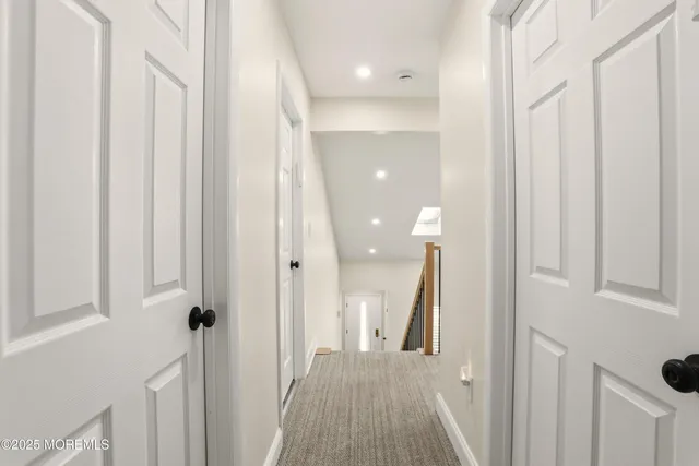 a view of a hallway with wooden floor and entryway
