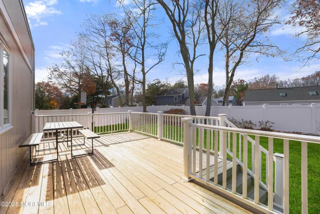 a view of balcony with wooden floor and fence