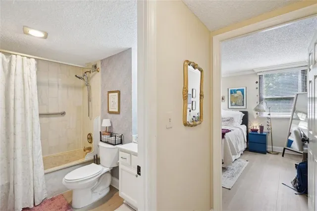 a bathroom with a granite countertop toilet sink and shower