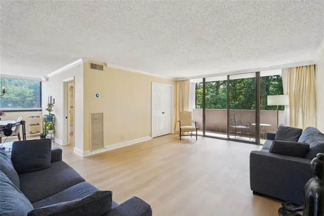 a living room with furniture and large windows