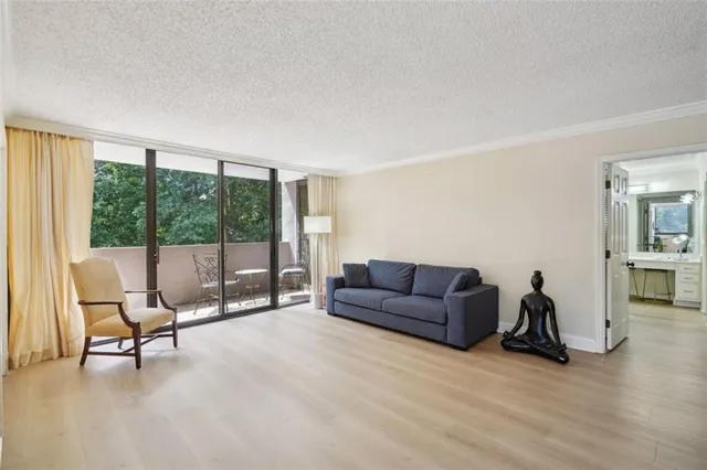 a living room with furniture and a floor to ceiling window
