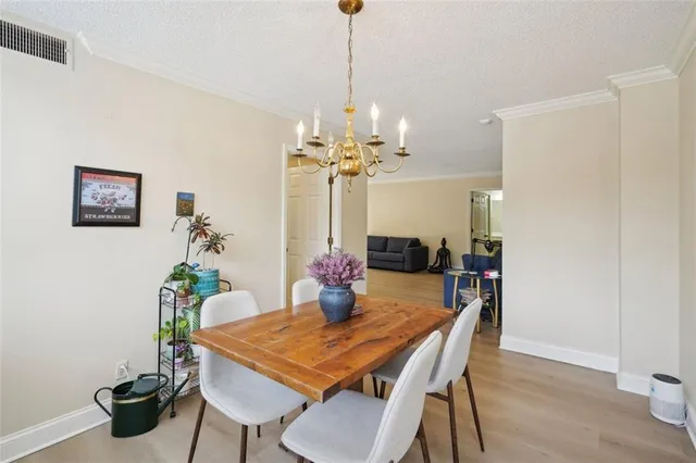 a dining room with furniture and chandelier