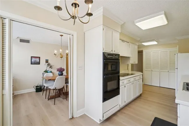 a kitchen with stainless steel appliances kitchen island granite countertop a refrigerator and a sink