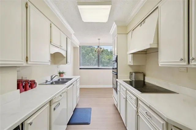 a kitchen that has a sink and a stove