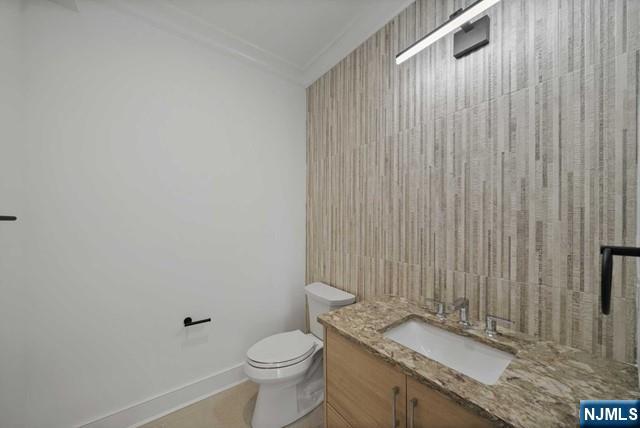 92 Franklin Street Tenafly, NJ 07670 - Photo 11 of 42 a bathroom with a granite countertop sink toilet and a mirror