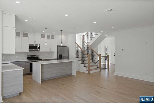 92 Franklin Street Tenafly, NJ 07670 - Photo 20 of 42 a large kitchen with stainless steel appliances a large counter top a stove and a refrigerator