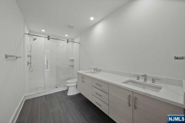 92 Franklin Street Tenafly, NJ 07670 - Photo 30 of 42 a spacious bathroom with a granite countertop sink a toilet and shower