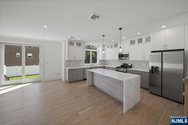 92 Franklin Street Tenafly, NJ 07670 - Photo 7 of 42 a kitchen with stainless steel appliances kitchen island granite countertop a refrigerator and a stove top oven