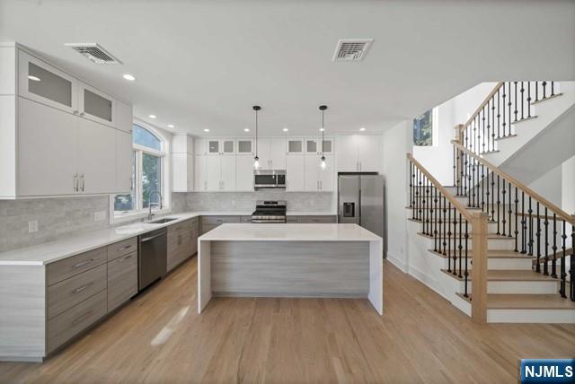 92 Franklin Street Tenafly, NJ 07670 - Photo 9 of 42 a large white kitchen with a large window and stainless steel appliances