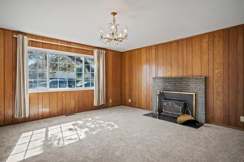 wooden floor fireplace and windows in an empty room