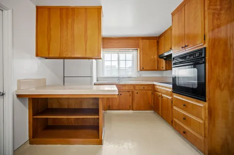 a kitchen with stainless steel appliances a stove a sink and a microwave
