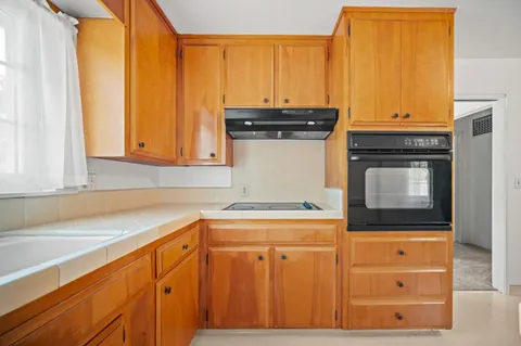 a view of a kitchen with a sink and cabinets