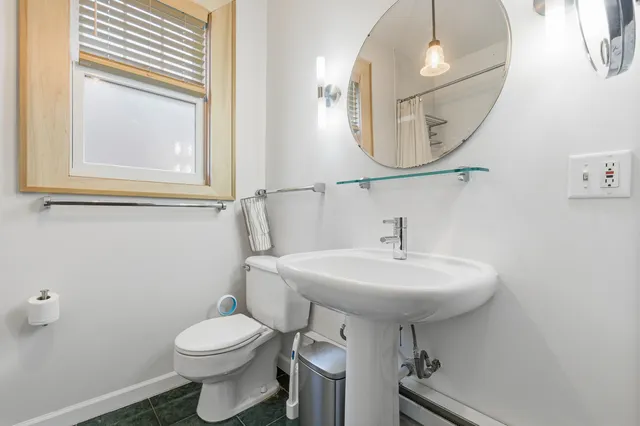 a bathroom with a sink a mirror and a toilet