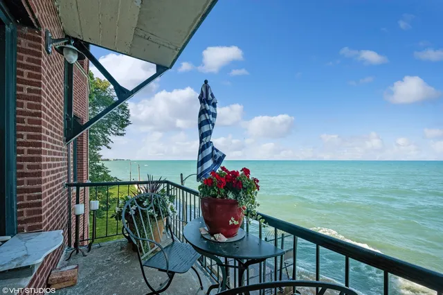 a view of a balcony with chair and table