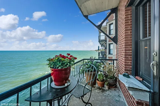 a view of a balcony with chair and potted plants