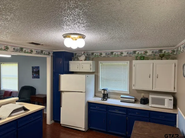 a kitchen with a refrigerator and a sink