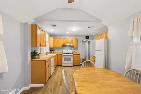 a large white kitchen with a large window
