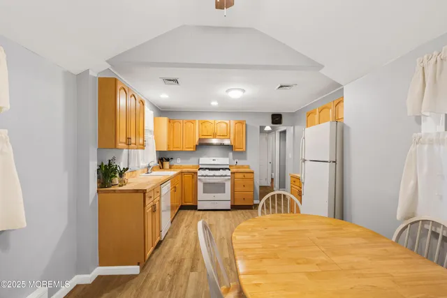 a large white kitchen with a large window
