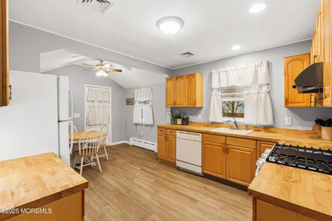 a large kitchen with a table and chairs in it