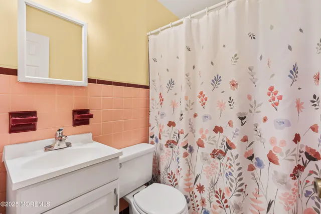 a bathroom with a sink toilet and mirror