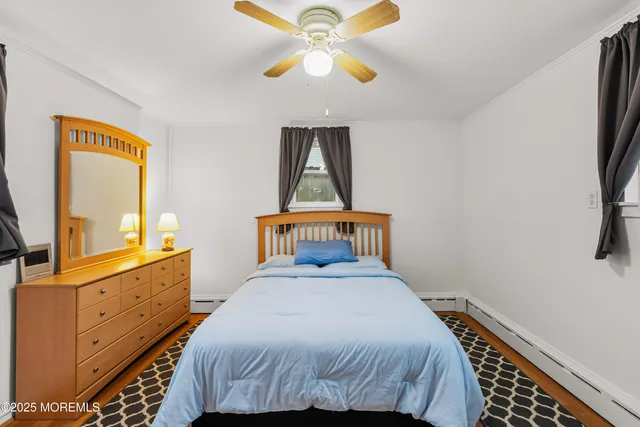 a bedroom with a bed and a chandelier fan