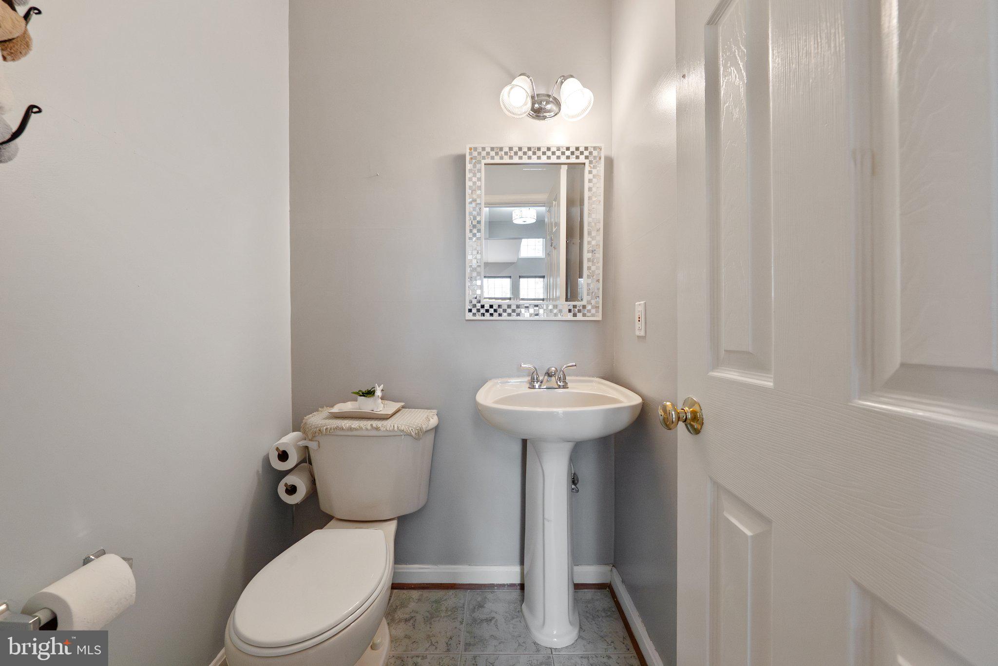 14387 Newbern Loop Gainesville, VA 20155 - Photo 12 of 38 a bathroom with a toilet sink and mirror