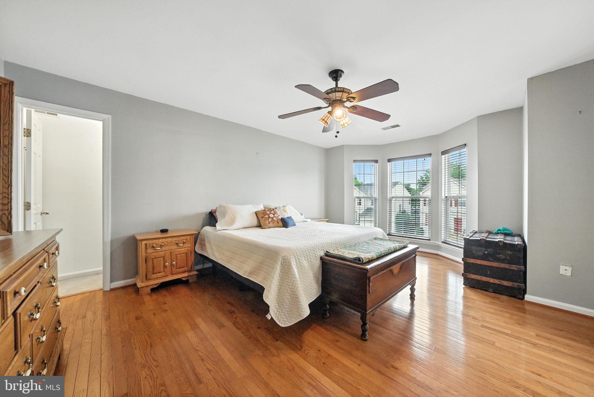 14387 Newbern Loop Gainesville, VA 20155 - Photo 13 of 38 a bedroom with a bed and wooden floor