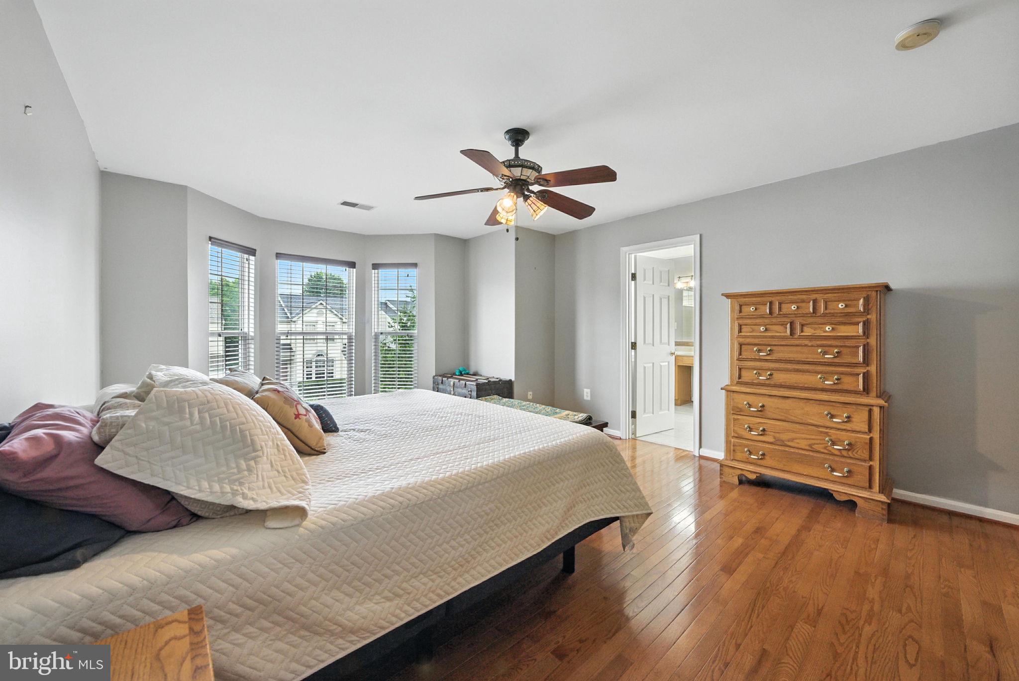 14387 Newbern Loop Gainesville, VA 20155 - Photo 14 of 38 a bedroom with a bed chandelier and a window