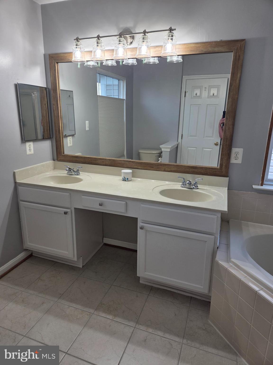 14387 Newbern Loop Gainesville, VA 20155 - Photo 17 of 38 a bathroom with a sink and a mirror