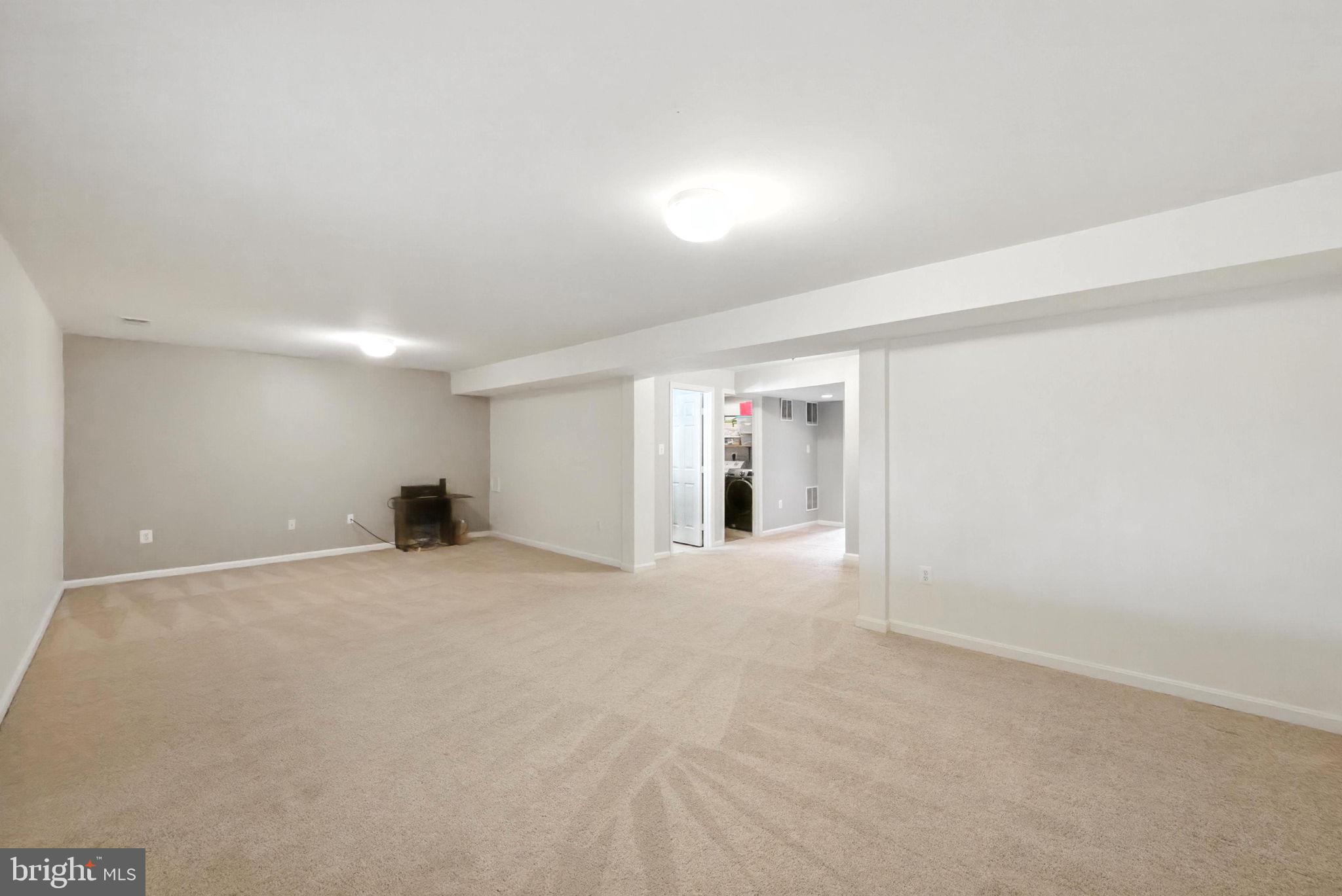 14387 Newbern Loop Gainesville, VA 20155 - Photo 23 of 38 a view of an empty room with wooden floor and windows