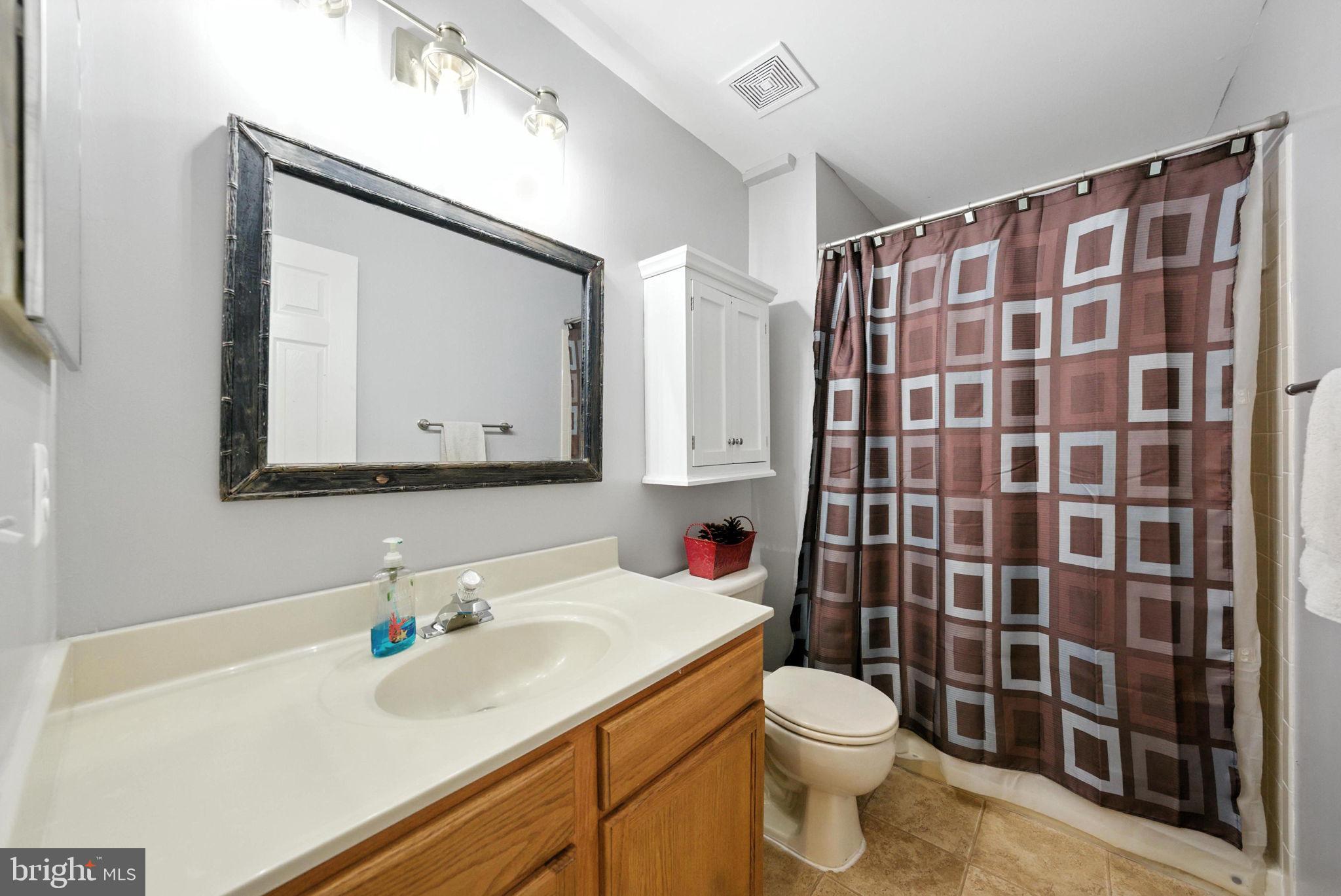14387 Newbern Loop Gainesville, VA 20155 - Photo 27 of 38 a bathroom with a sink toilet and shower
