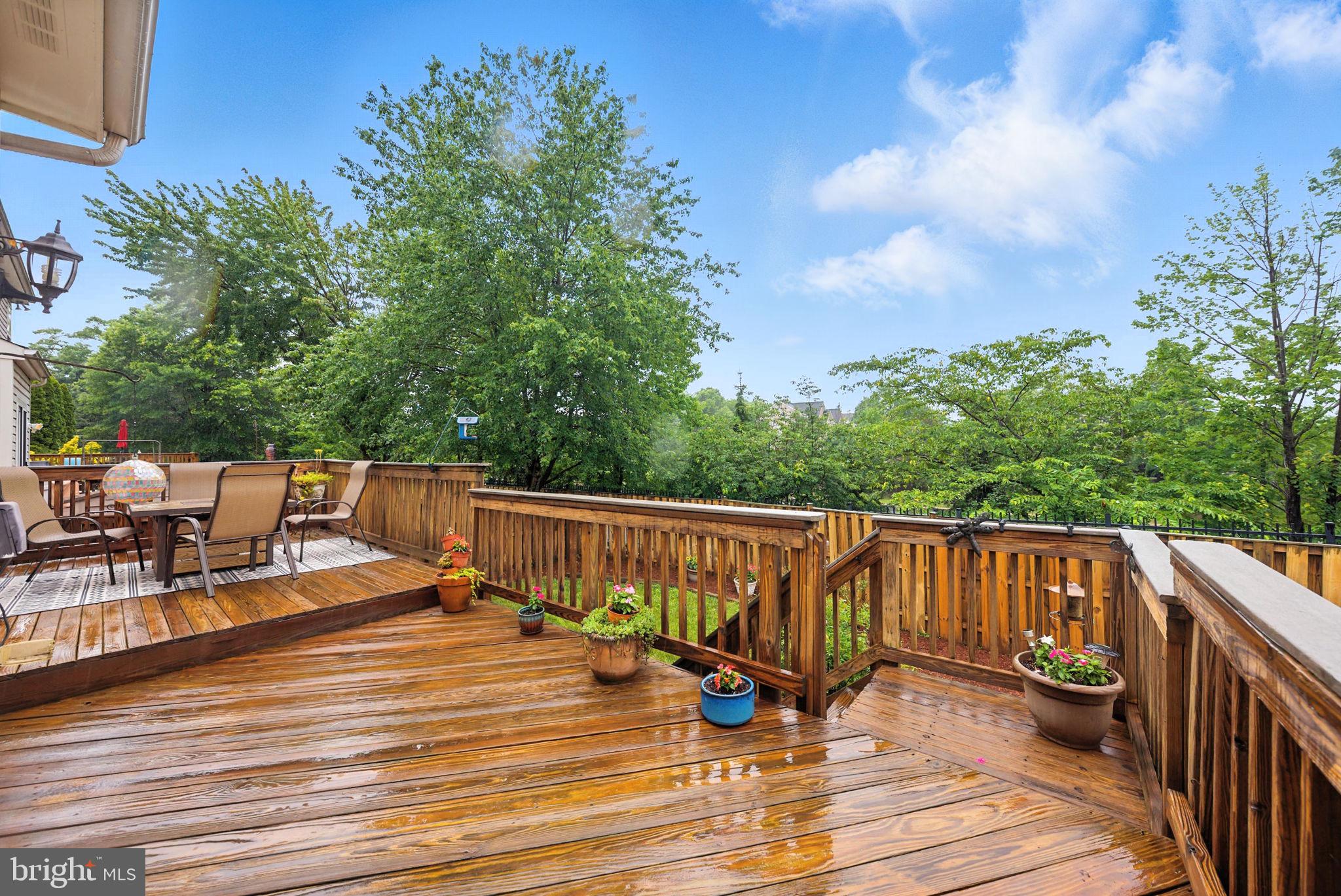 14387 Newbern Loop Gainesville, VA 20155 - Photo 31 of 38 a view of roof deck with chairs and wooden floor